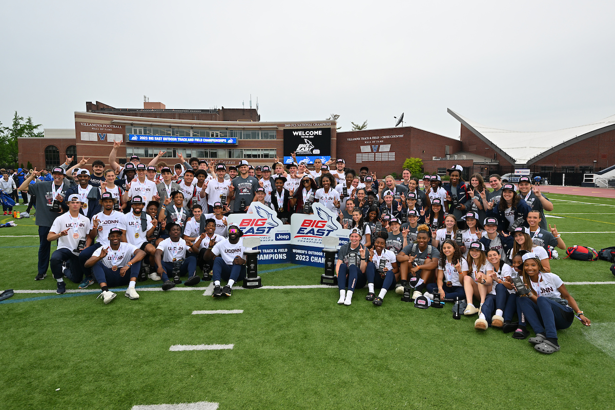 Men's and women's track & field teams pose with their BIG EAST Championship trophies